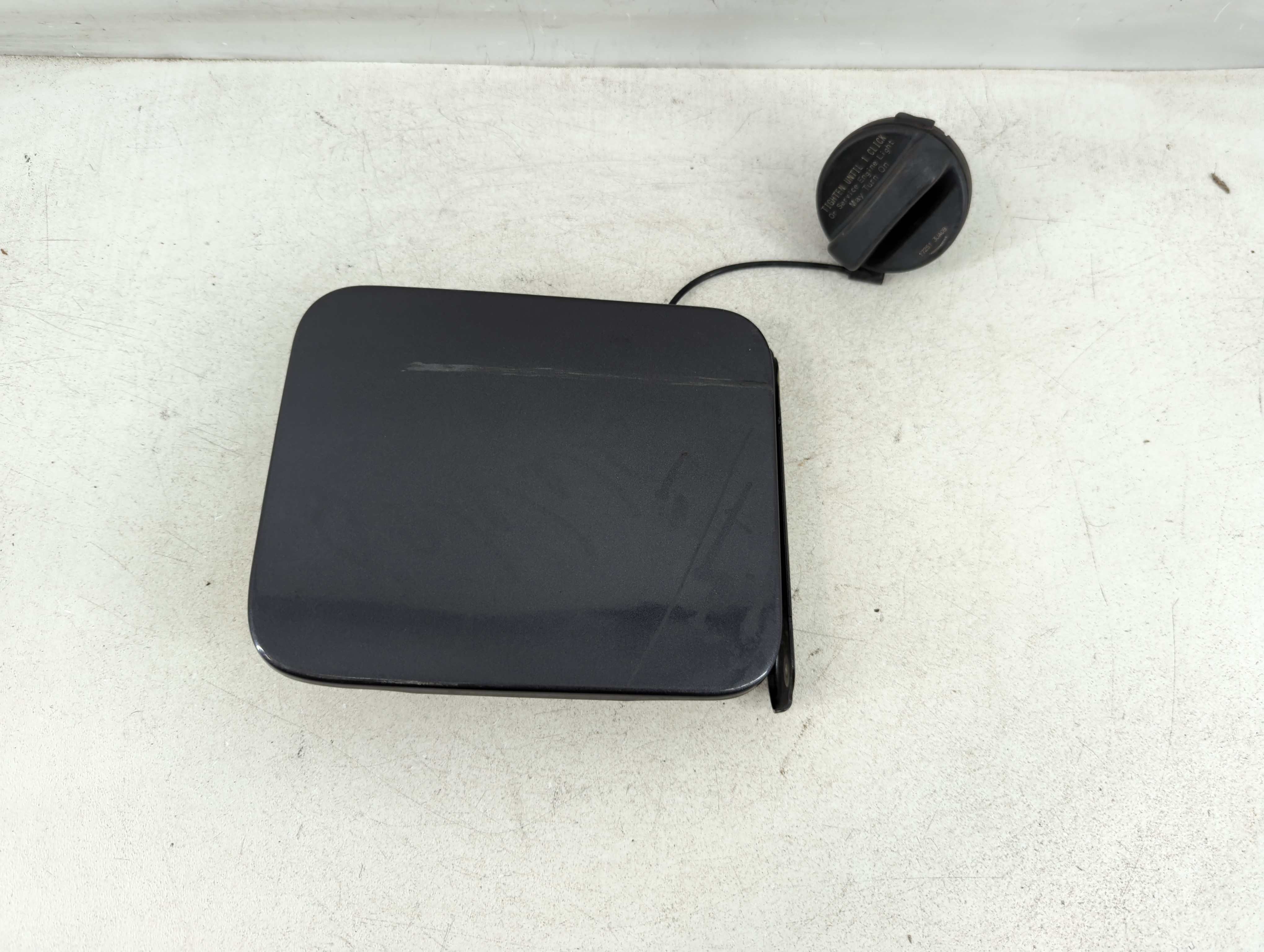 Picture of 2015 Nissan Versa Fuel Tank Door Lid Gas Tank Black 1080657