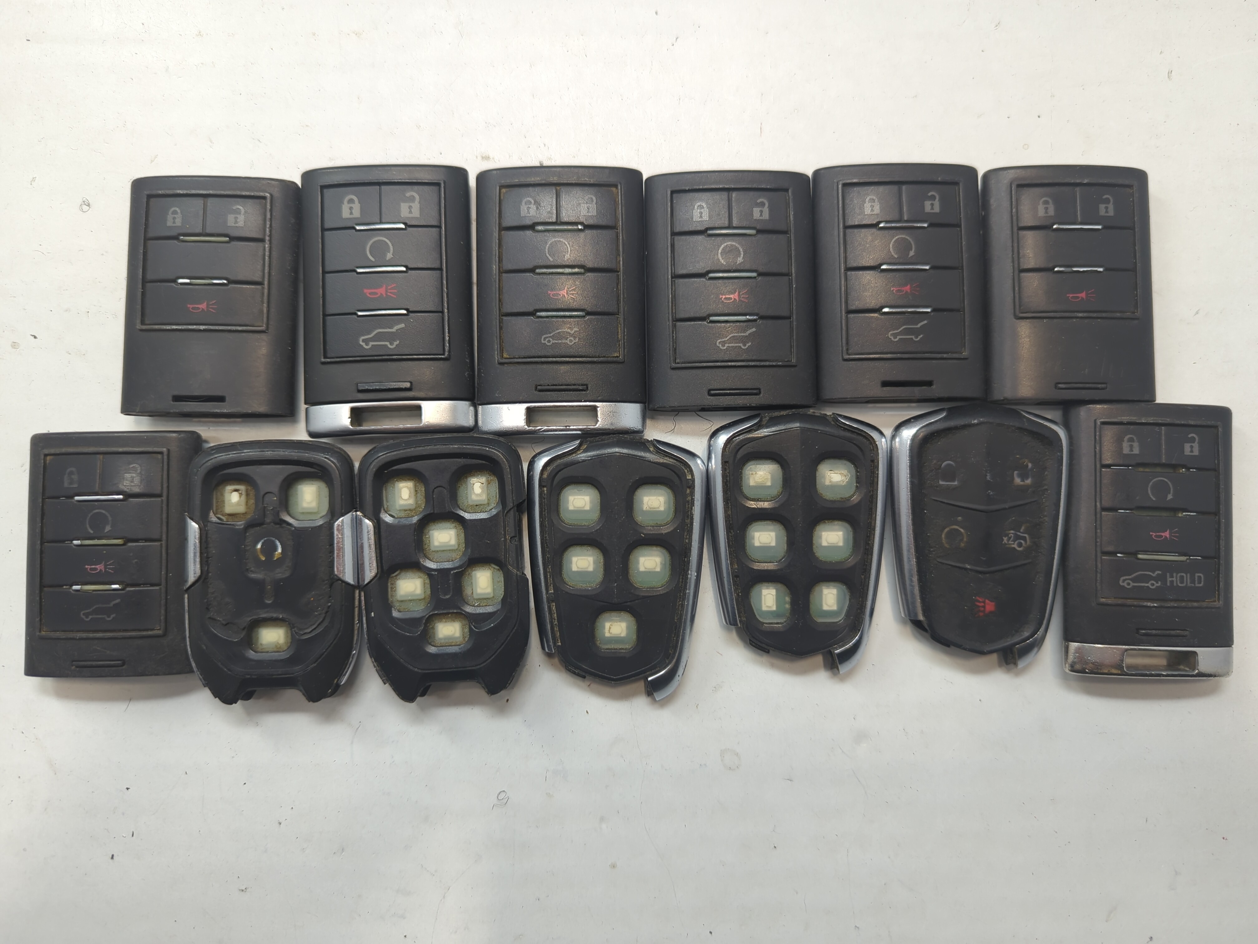 Lot of 13 Cadillac Keyless Entry Remote Fob MIXED FCC IDS MIXED PART 759026 - Oemusedautoparts1.com